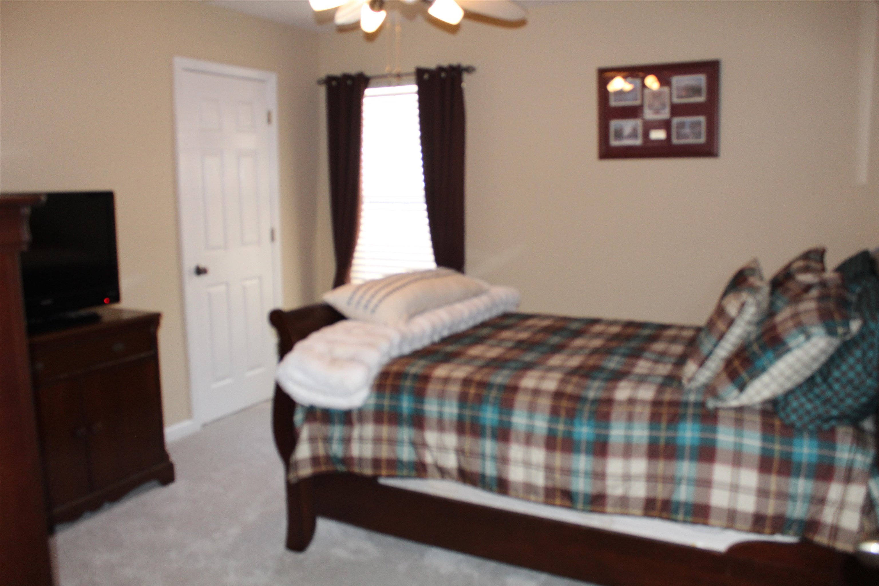 6442 Bending River Road Bartlett, TN 38135 - Photo 15 of 21 a bedroom with a bed and a television