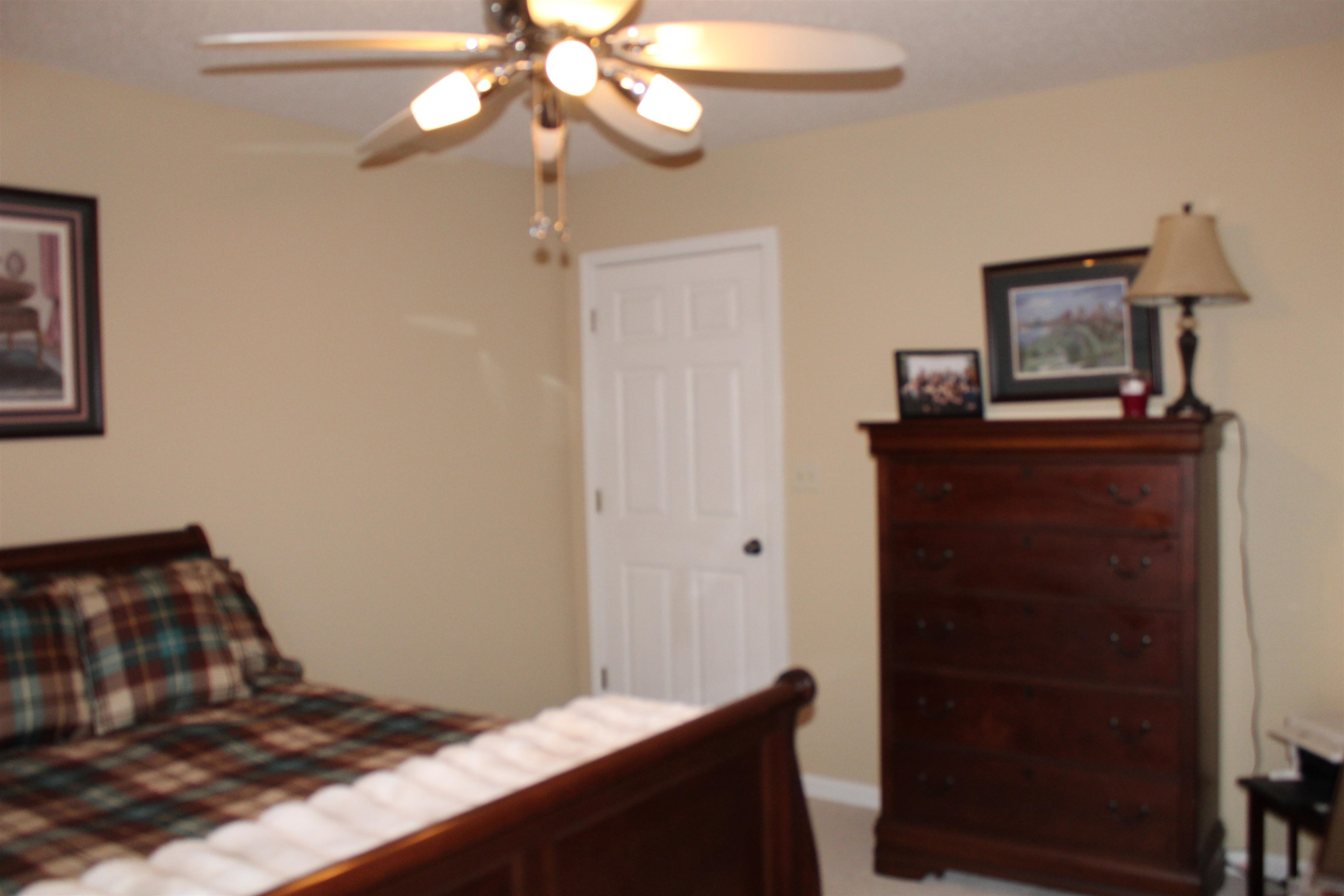 6442 Bending River Road Bartlett, TN 38135 - Photo 16 of 21 a bedroom with a bed and wooden floor