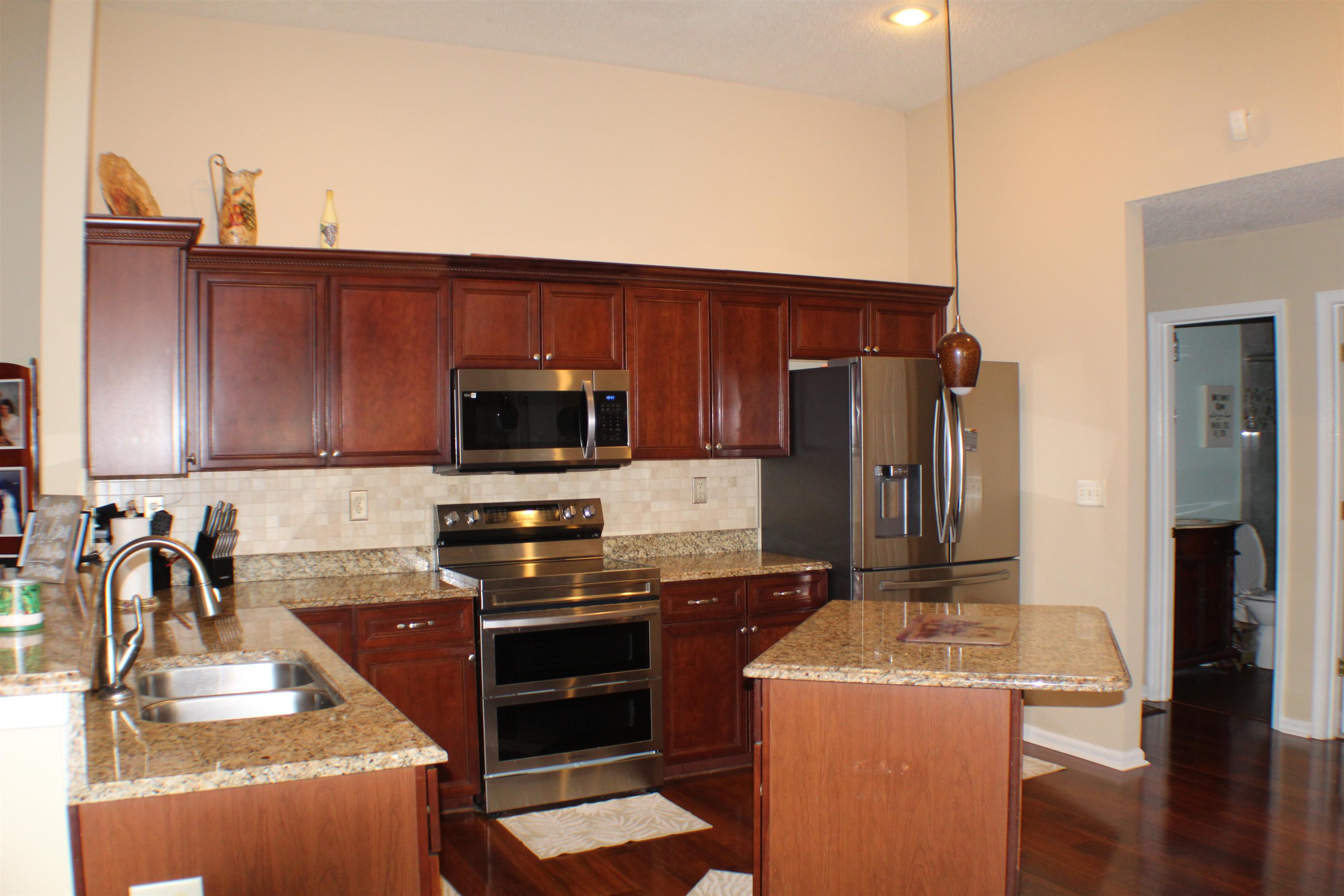 6442 Bending River Road Bartlett, TN 38135 - Photo 3 of 21 a kitchen with stainless steel appliances granite countertop a refrigerator stove and sink