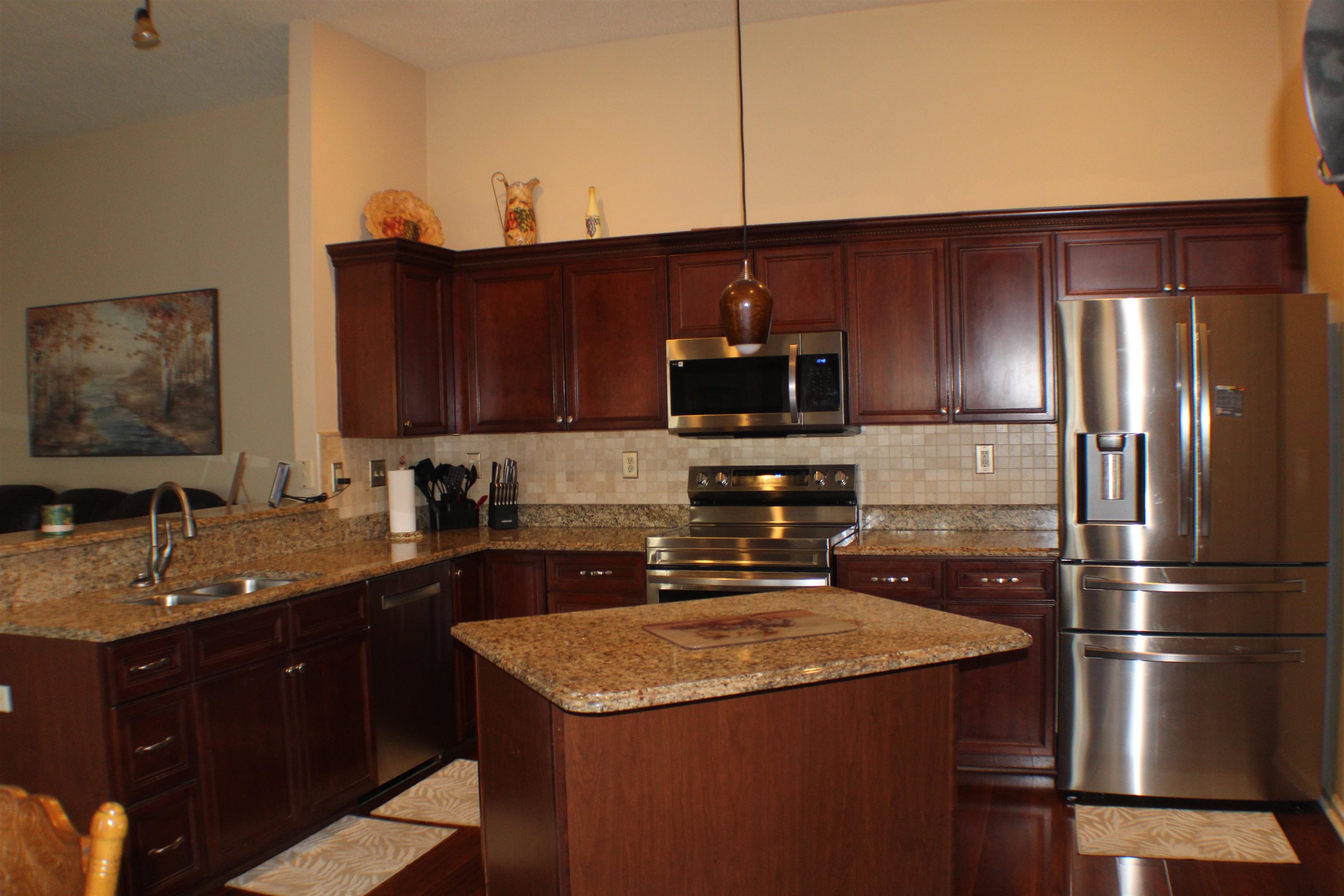 6442 Bending River Road Bartlett, TN 38135 - Photo 4 of 21 a kitchen with a sink a microwave a refrigerator and cabinets