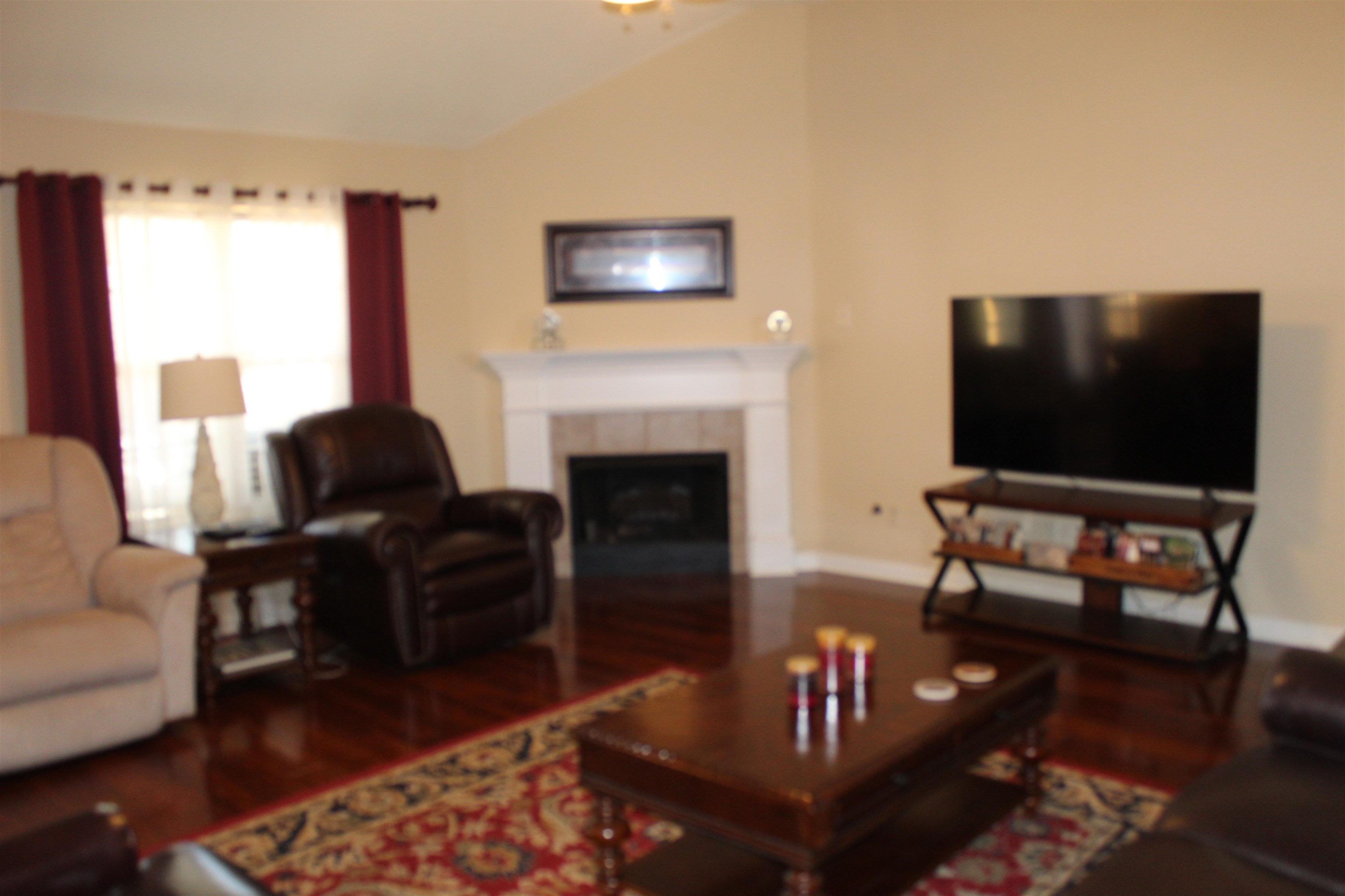 6442 Bending River Road Bartlett, TN 38135 - Photo 8 of 21 a living room with furniture a flat screen tv and a fireplace