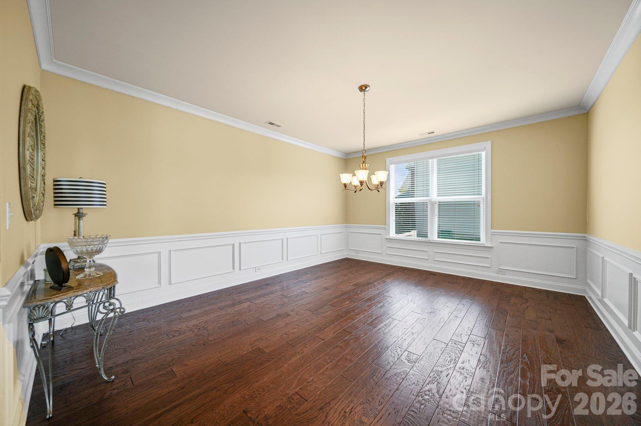 9639 Lockwood Road Concord, NC 28027 - Photo 12 of 33 a view of an empty room with wooden floor and a window