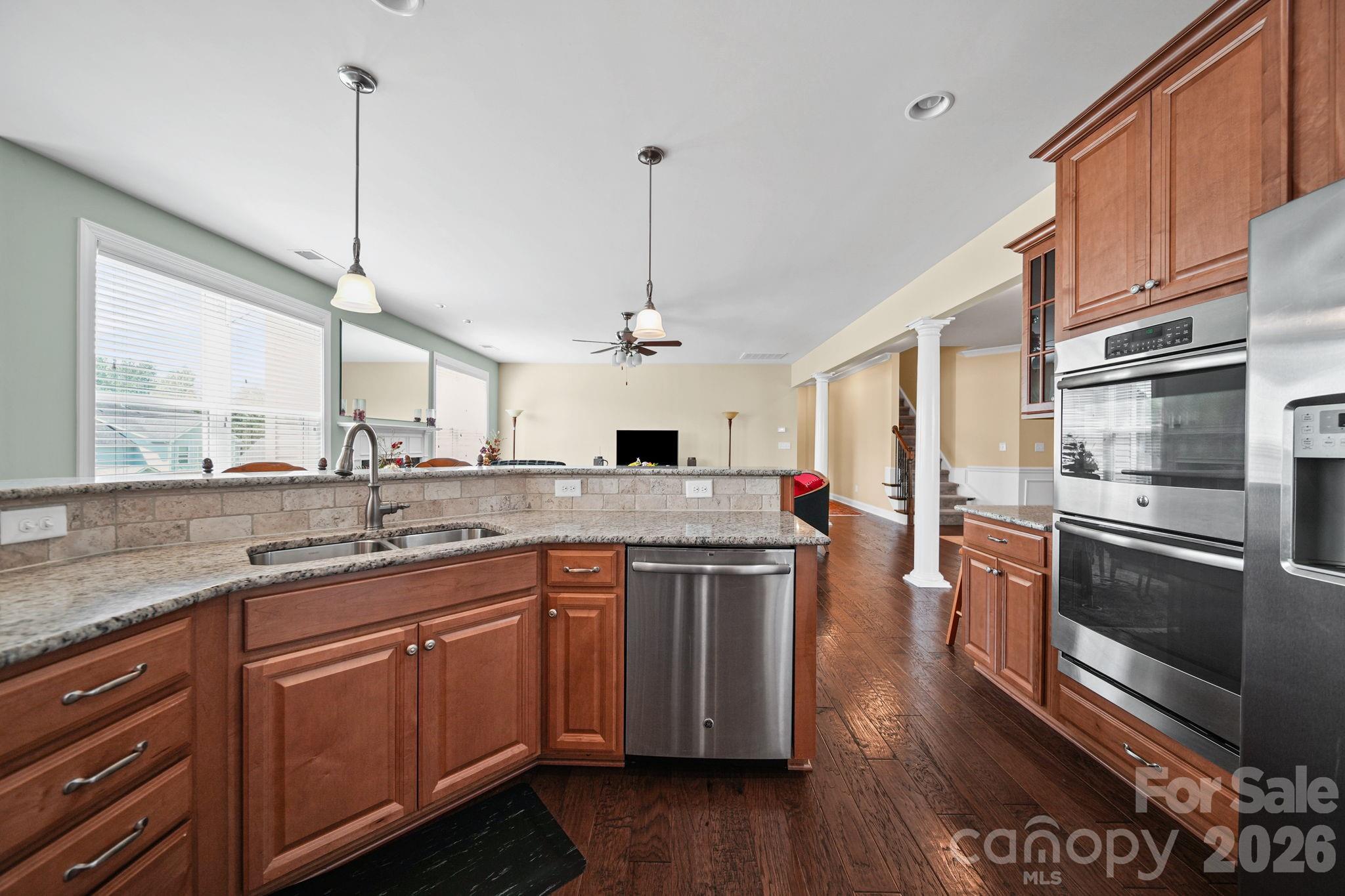 9639 Lockwood Road Concord, NC 28027 - Photo 15 of 33 a kitchen with stainless steel appliances granite countertop a sink a stove and a wooden floors