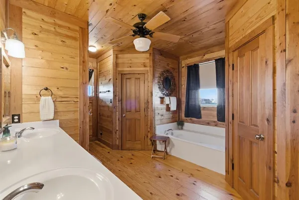 a bathroom with a sink a large mirror and a shower