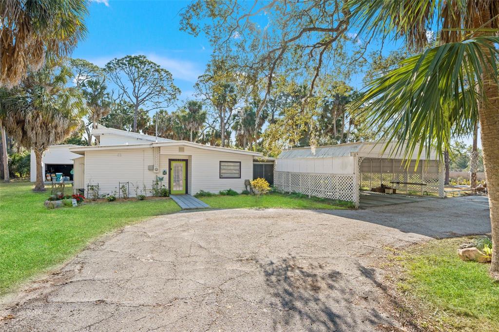 1524 Indian Bay Road Hernando Beach, FL 34607 - Photo 1 of 48 a front view of a house with a yard and a garage