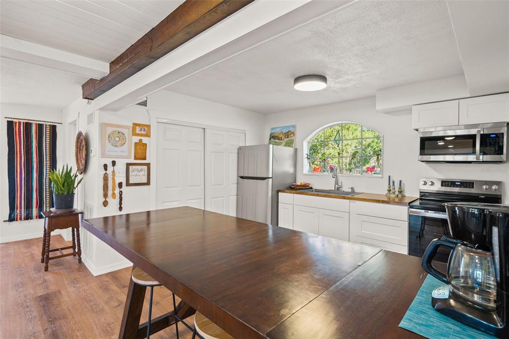 1524 Indian Bay Road Hernando Beach, FL 34607 - Photo 11 of 48 a kitchen with stainless steel appliances granite countertop a stove refrigerator and a wooden cabinets