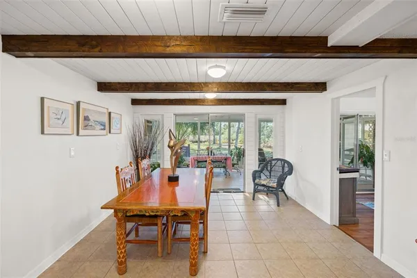 a dining room with furniture and wooden floor