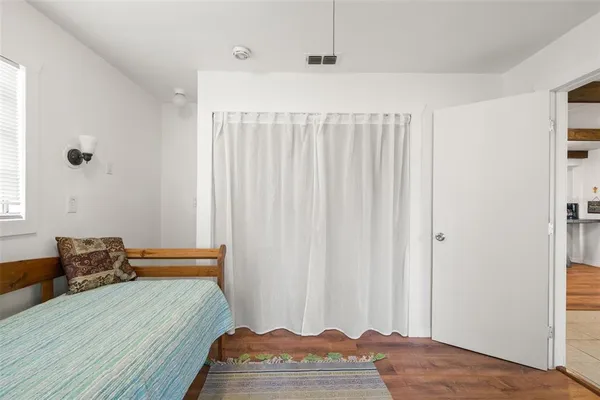 a bedroom with a bed and a window