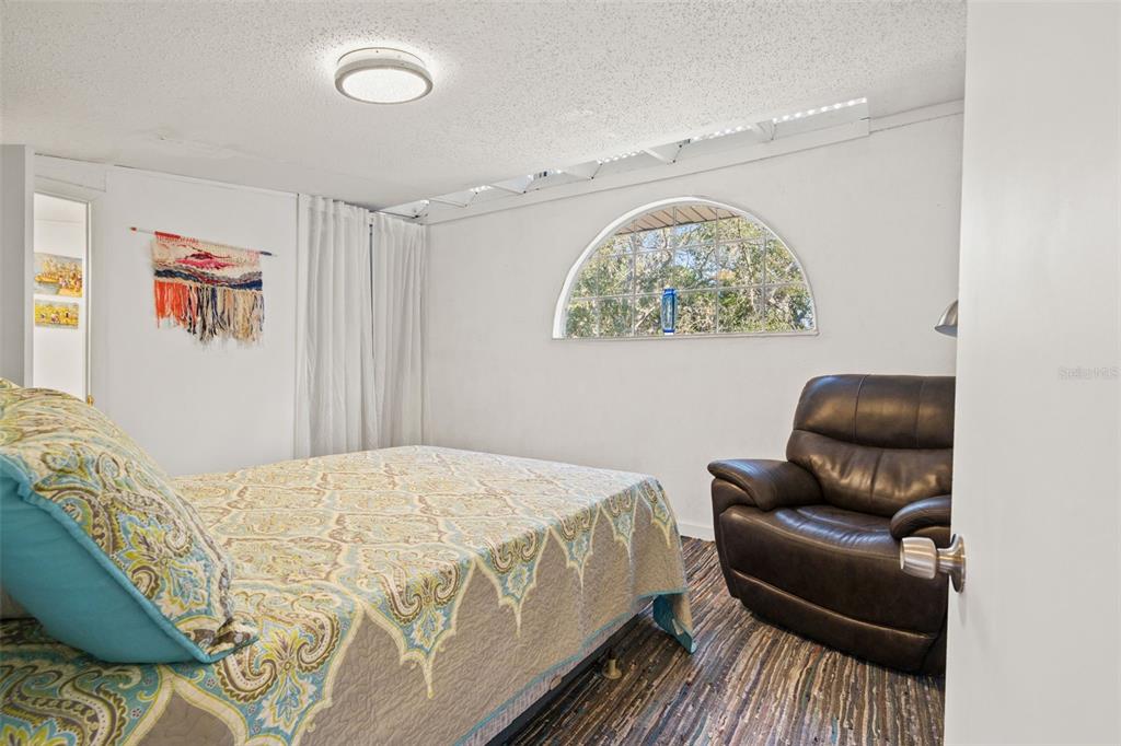 1524 Indian Bay Road Hernando Beach, FL 34607 - Photo 22 of 48 a bedroom with a bed and a couch