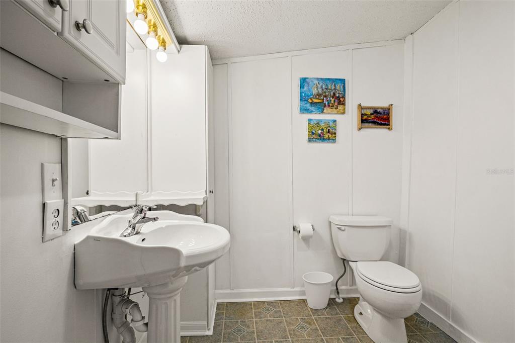1524 Indian Bay Road Hernando Beach, FL 34607 - Photo 24 of 48 a bathroom with a toilet a sink and a mirror