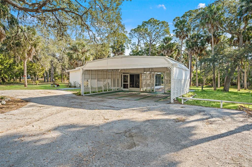 1524 Indian Bay Road Hernando Beach, FL 34607 - Photo 29 of 48 a front view of a house with a yard