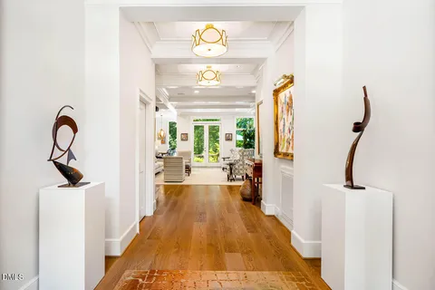 a kitchen with stainless steel appliances granite countertop wooden floor a dining table and chairs