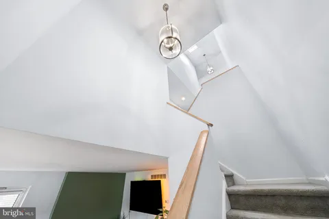 a bed sitting in a spacious bedroom next to a window