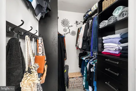 a spacious bedroom with furniture and a large window