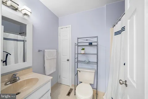 a hallway with stairs and wooden floor