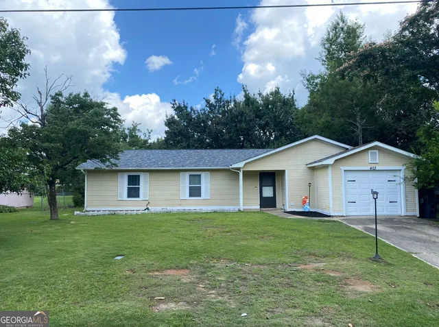 a view of a house with yard and tree s