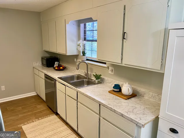 a kitchen with stainless steel appliances granite countertop a sink stove and cabinets