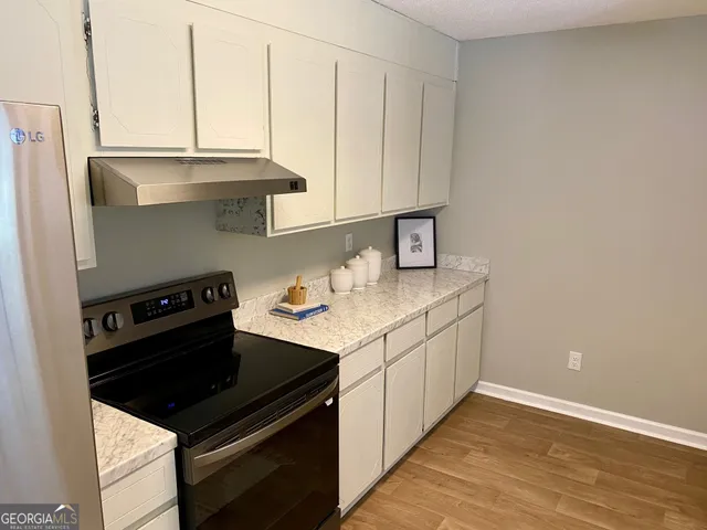 a kitchen with a sink stove and cabinets