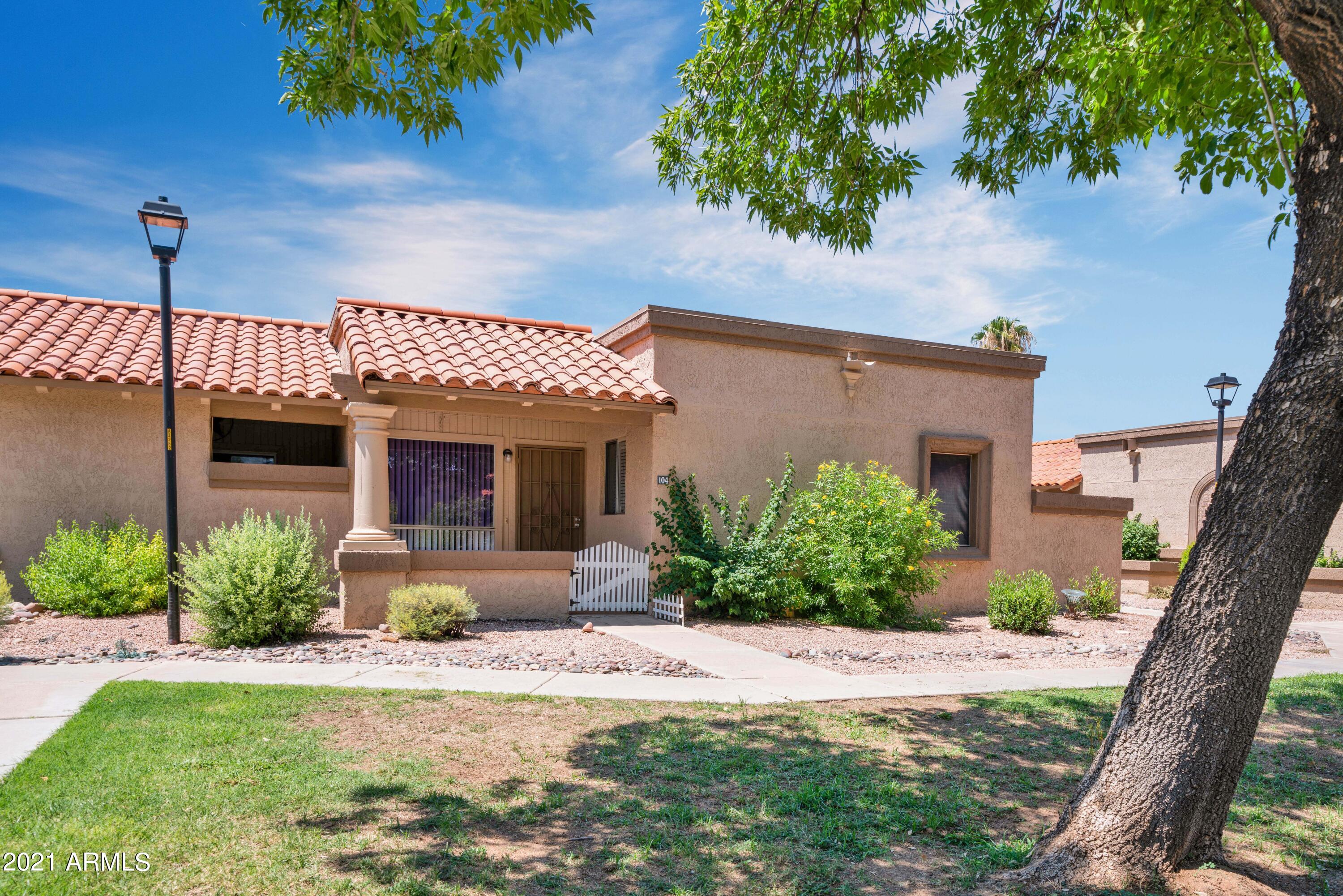97 North Cooper Road, Unit 104 Chandler, AZ 85225 - Photo 3 of 27 a front view of a house with garden