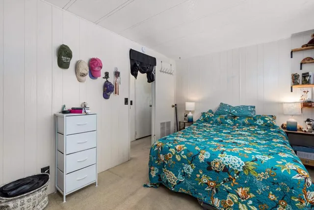 a bedroom with a bed and a dresser in it