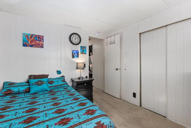 a bed room with a bed and a table in it