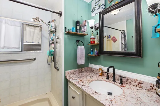 a bathroom with a sink vanity and a mirror