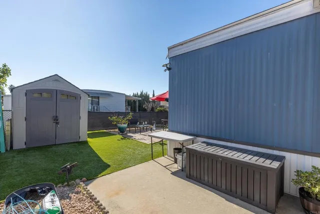 a view of a backyard with sitting area