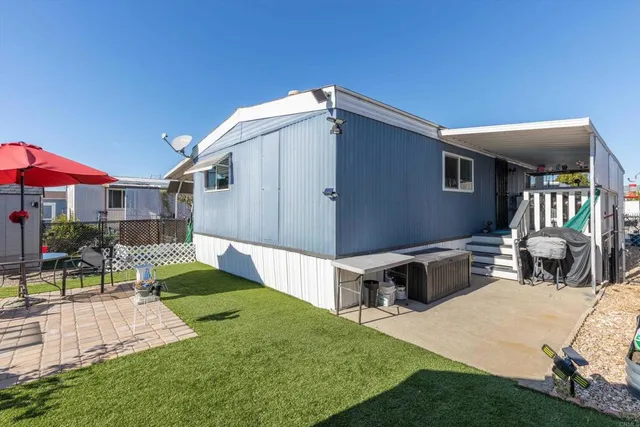 a front view of house with yard and outdoor seating