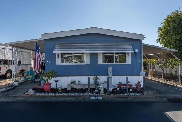 a front view of a house with sitting area