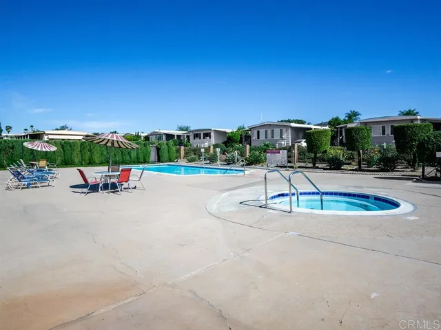 a swimming pool with outdoor seating and yard