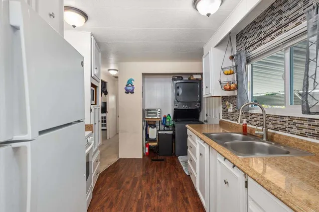 a kitchen with a sink a counter top space stainless steel appliances