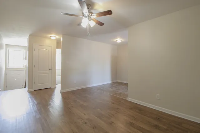 a view of an empty room with wooden floor