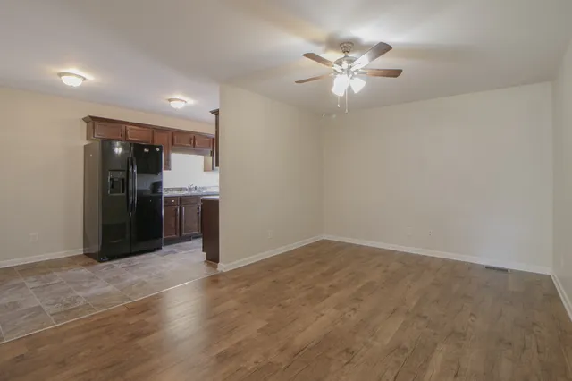 a view of kitchen with refrigerator and ceiling fan