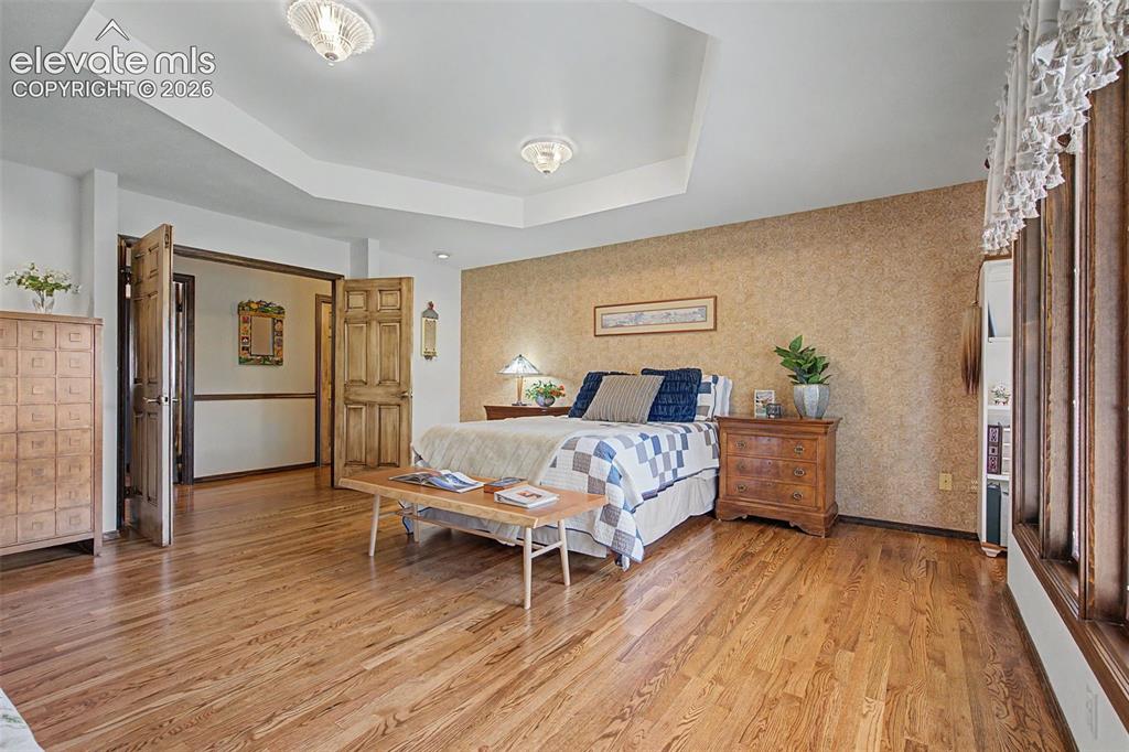 8020 Westwood Road Colorado Springs, CO 80919 - Photo 20 of 50 Not just a primary suite, a grand suite with plenty of room for furniture, amazing natural light, and a very large en suite.