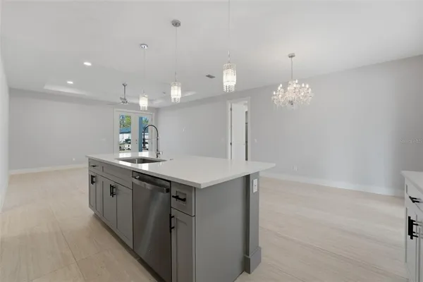 a kitchen with a sink and chandelier