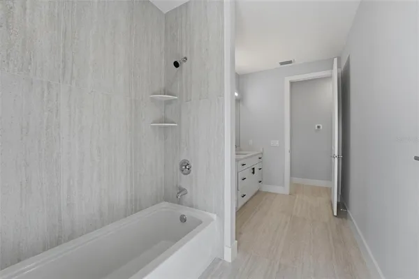 a bathroom with a bathtub and shower