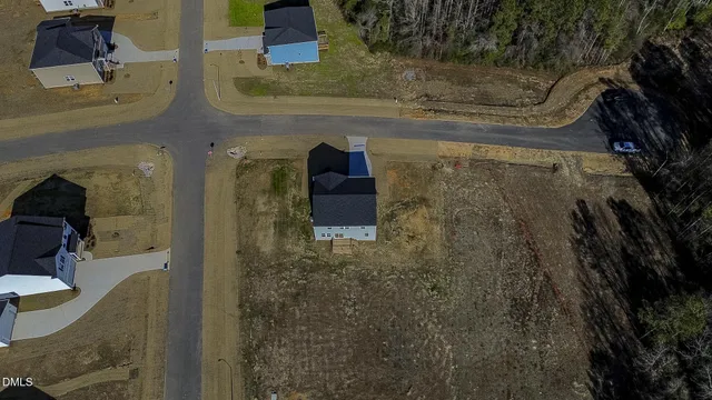 a view of a kitchen with kitchen island a sink wooden floor and a living room