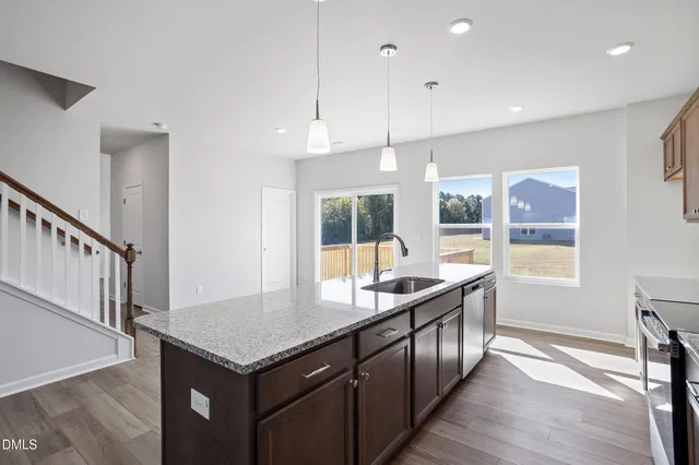 a view of a kitchen with wooden floor and a kitchen