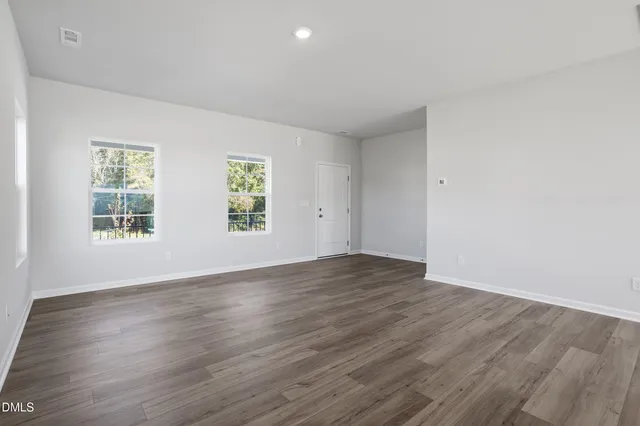 a view of a kitchen from the hallway with a window