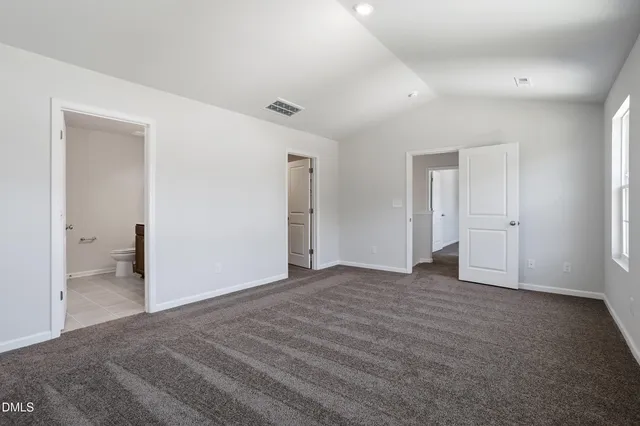 a bathroom with a granite countertop sink a toilet and a mirror