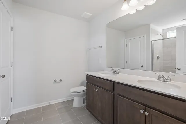 a bathroom with a glass shower door