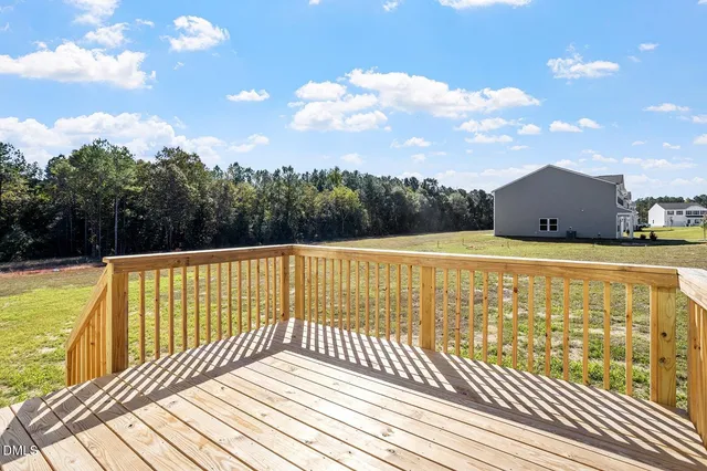 a view of balcony with wooden floor and fence
