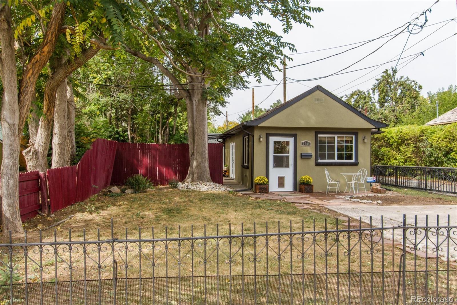 3705 Zuni Street Denver, CO 80211 - Photo 1 of 15 a view of a house with a small yard and wooden fence