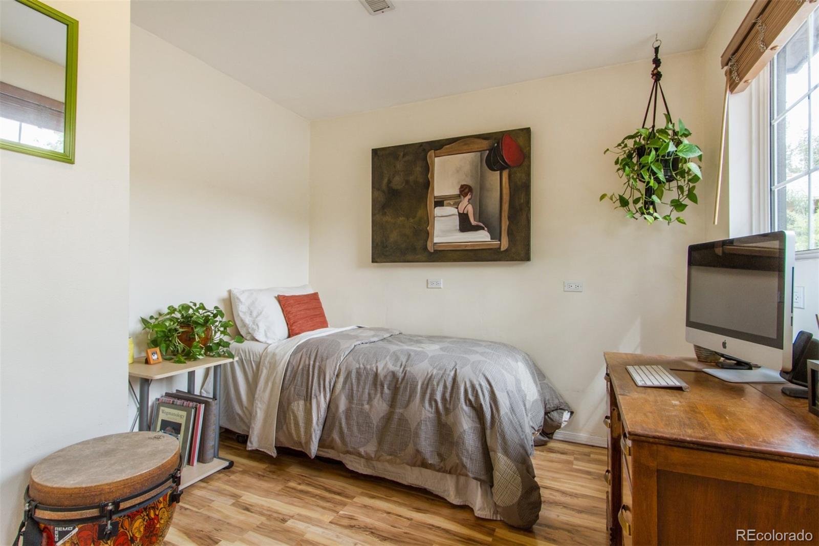 3705 Zuni Street Denver, CO 80211 - Photo 12 of 15 a bedroom with a bed and a table in it
