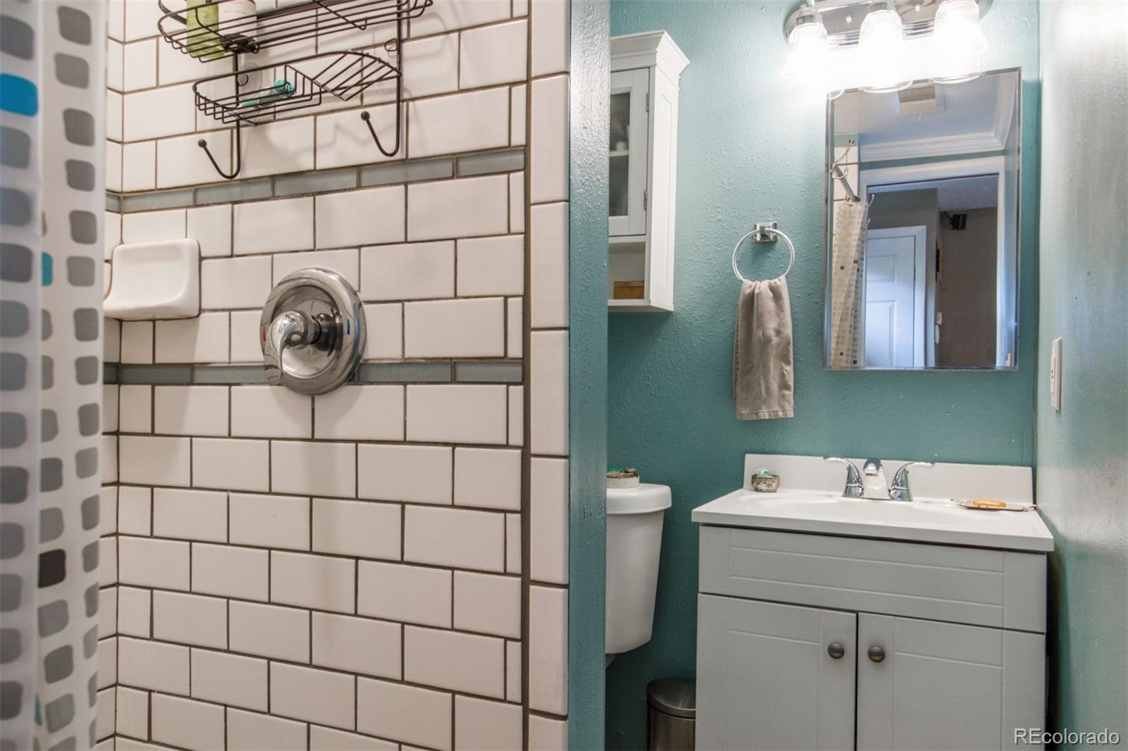 3705 Zuni Street Denver, CO 80211 - Photo 13 of 15 a bathroom with a sink and a mirror