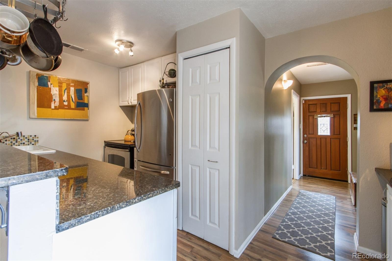 3705 Zuni Street Denver, CO 80211 - Photo 4 of 15 a view of kitchen island with furniture and wooden floor