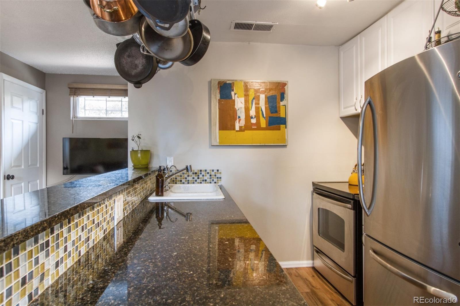 3705 Zuni Street Denver, CO 80211 - Photo 5 of 15 a bathroom with a sink a mirror and a bathtub