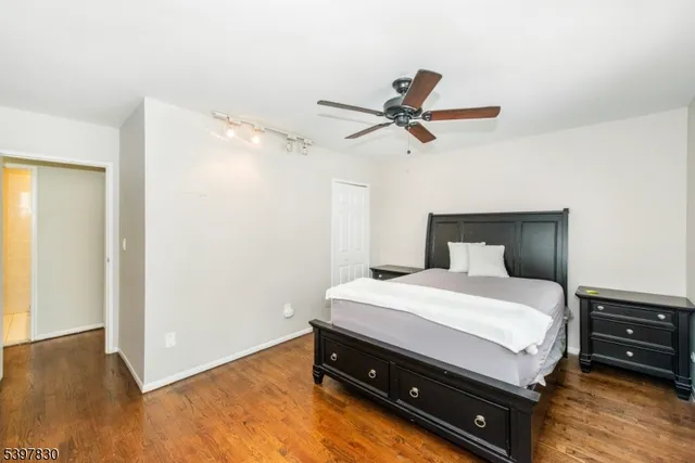 a bedroom with a bed and a ceiling fan