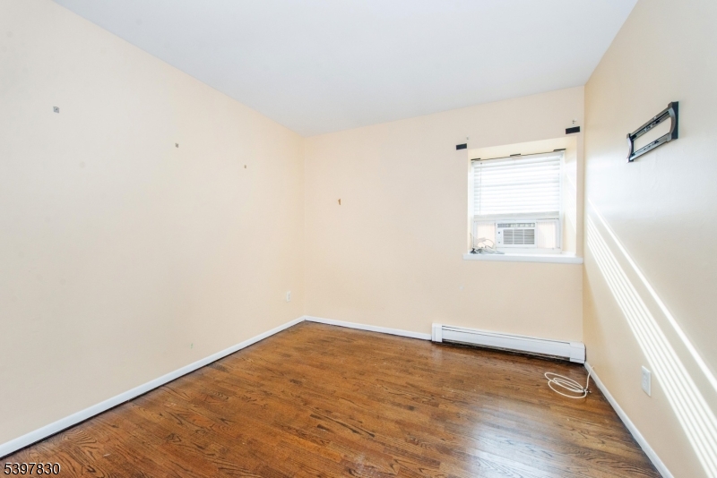 25 River Road, Unit A14 Nutley, NJ 07110 - Photo 17 of 21 a view of empty room with wooden floor and fan