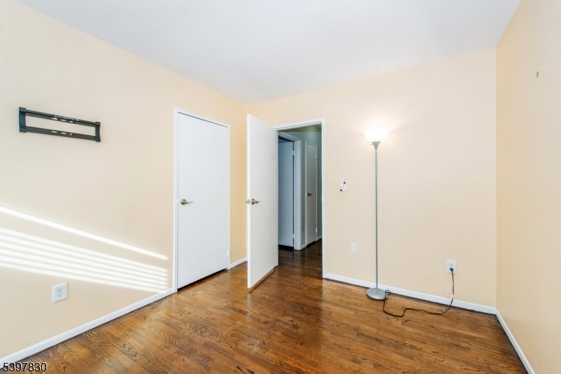 25 River Road, Unit A14 Nutley, NJ 07110 - Photo 18 of 21 a view of an empty room with wooden floor